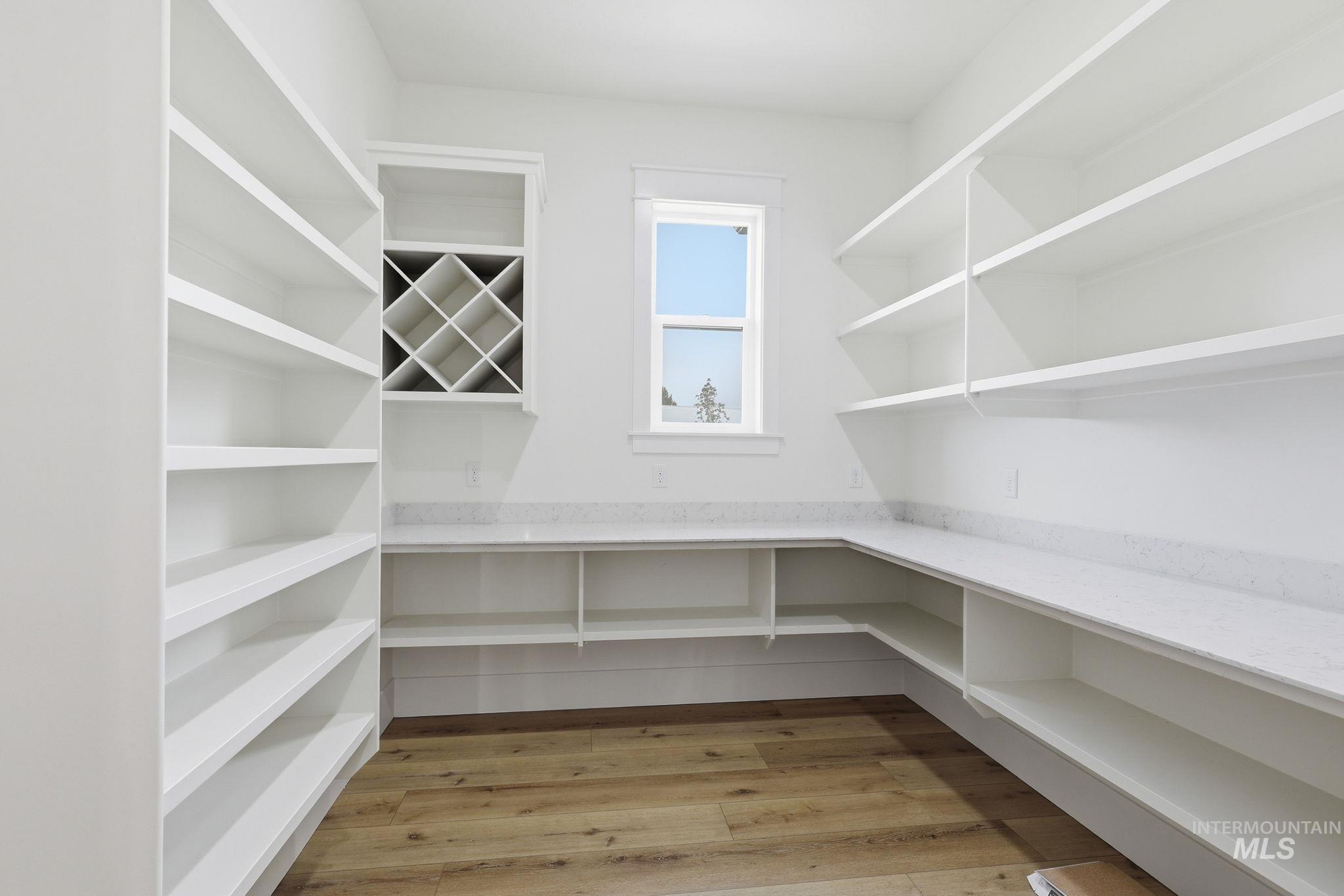 2321 Lower Bluff Road Emmett, ID 83617 - Photo 6 of 31 Spacious room featuring a dark accent wall with vertical paneling, light wood-finish flooring, and white baseboards