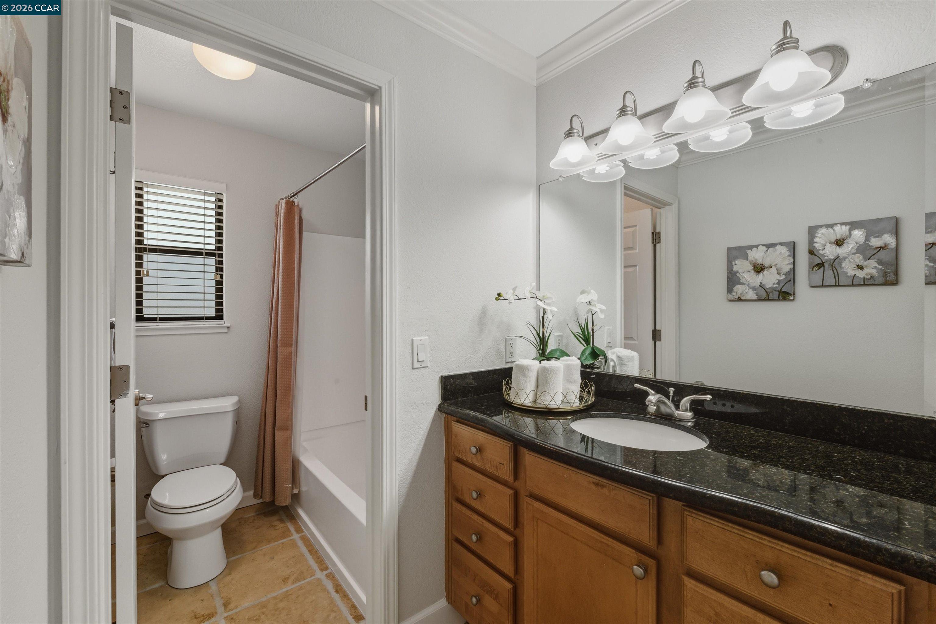 332 Eastridge Drive San Ramon, CA 94582 - Photo 24 of 41 a bathroom with a granite countertop sink a toilet and a mirror