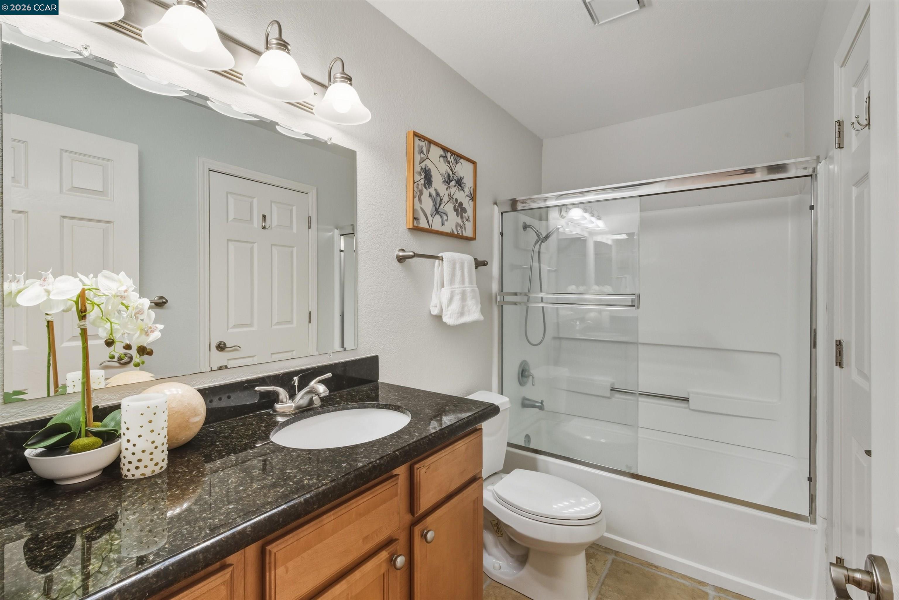 332 Eastridge Drive San Ramon, CA 94582 - Photo 29 of 41 a bathroom with a granite countertop sink a toilet and a mirror
