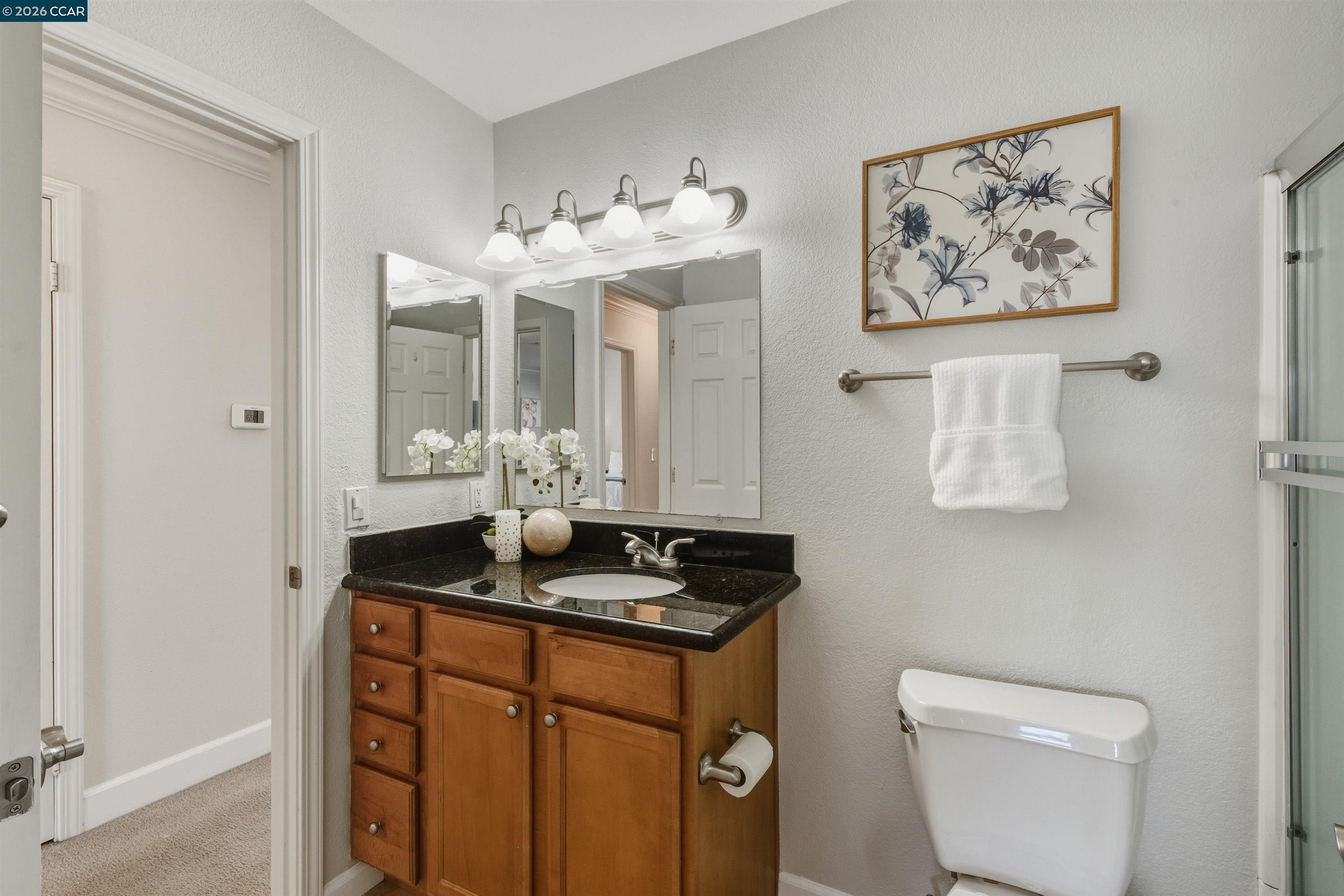 332 Eastridge Drive San Ramon, CA 94582 - Photo 30 of 41 a bathroom with a granite countertop sink mirror and toilet