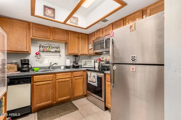 a kitchen with stainless steel appliances granite countertop a refrigerator sink and cabinets