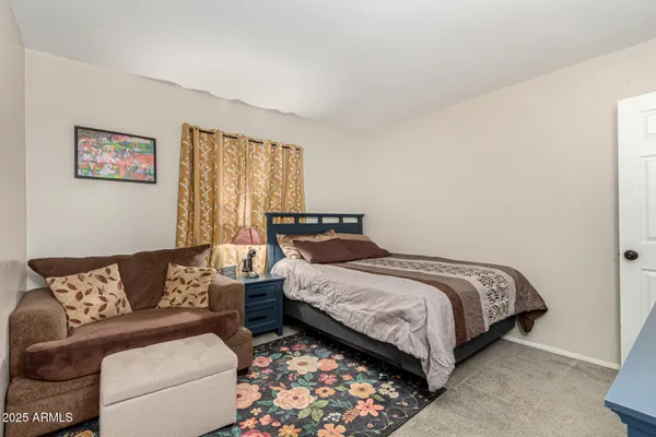 a bedroom with a bed couch and a couch