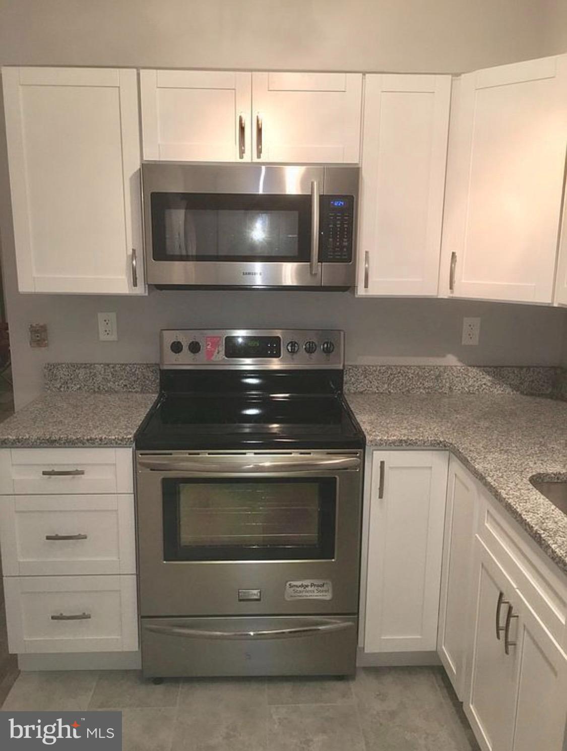 540 Willow Turn, Unit A Mount Laurel, NJ 08054 - Photo 11 of 12 a kitchen with granite countertop white cabinets and stainless steel appliances