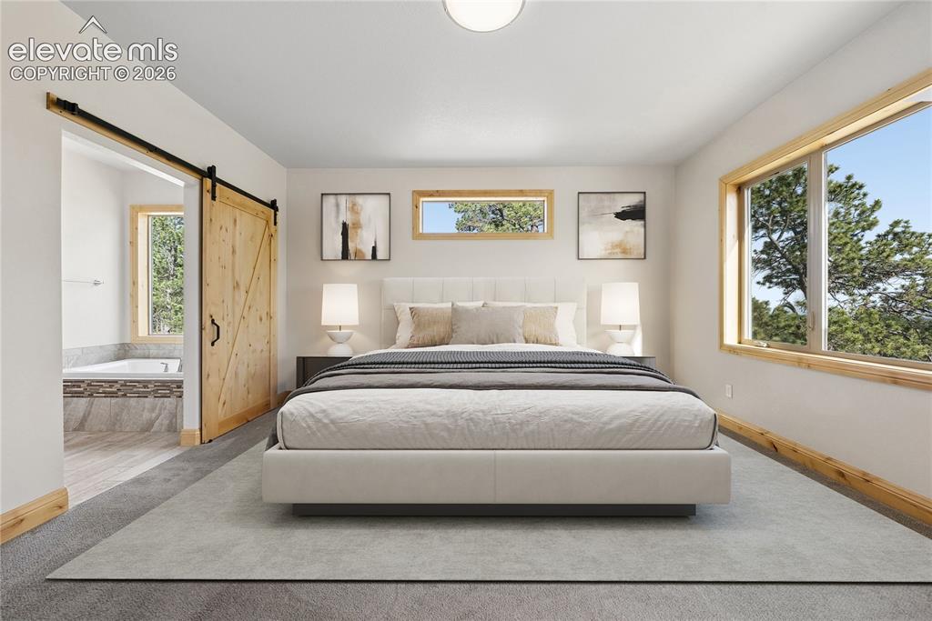 10840 Vollmer Road Colorado Springs, CO 80908 - Photo 25 of 49 a spacious bedroom with a bed and glass window