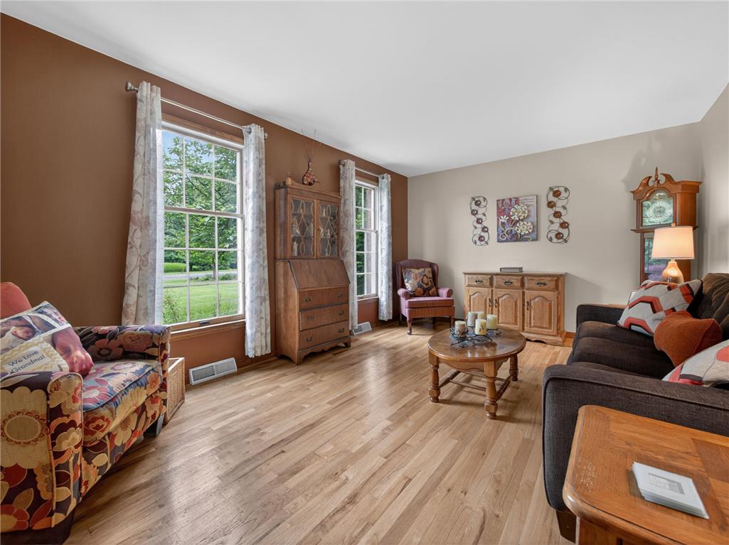 853 Lahr Road Nazareth, PA 18064 - Photo 6 of 29 Sun-filled living space featuring natural wood flooring and multiple windows framing garden views.
