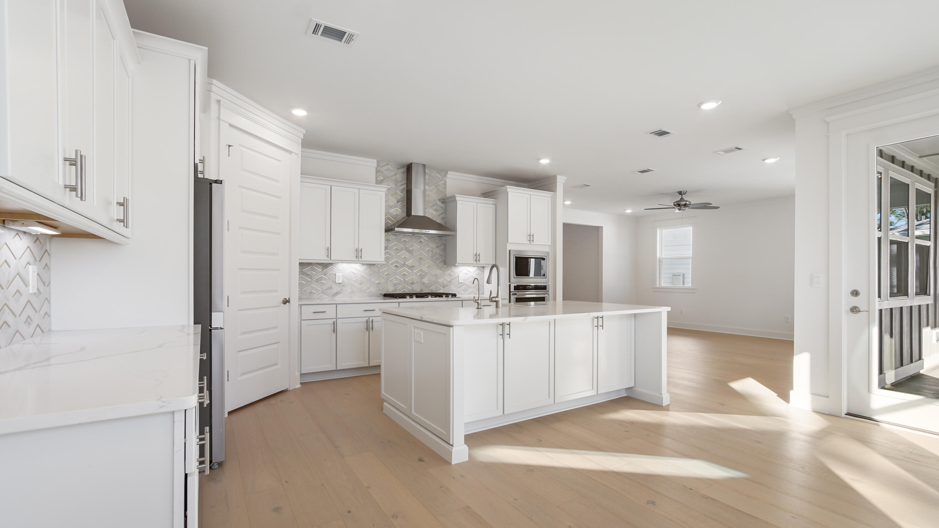 25 Ashwood Drive Santa Rosa Beach, FL 32459 - Photo 11 of 54 a large white kitchen with stainless steel appliances