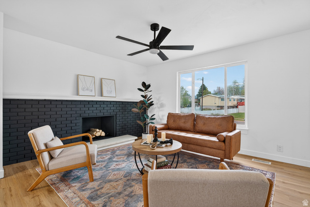 489 Owens Street Layton, UT 84041 - Photo 4 of 25 Living area with wood finished floors, a fireplace, and ceiling fan