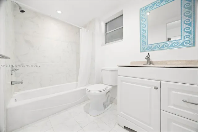 a bathroom with a toilet a sink and a bathtub