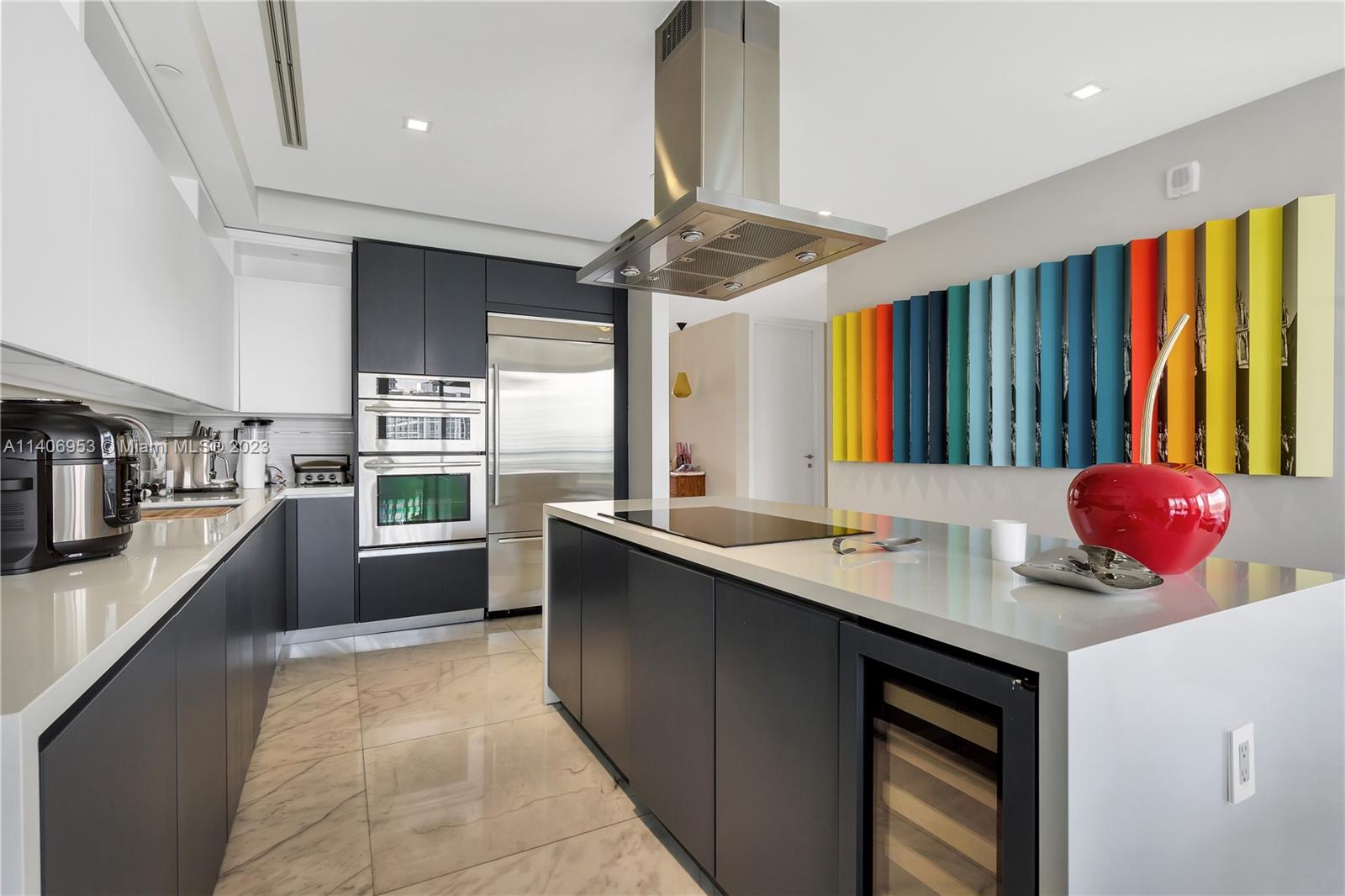 Brickell Miami, FL 33131 - Photo 11 of 41 a kitchen with kitchen island granite countertop a sink stove and cabinets
