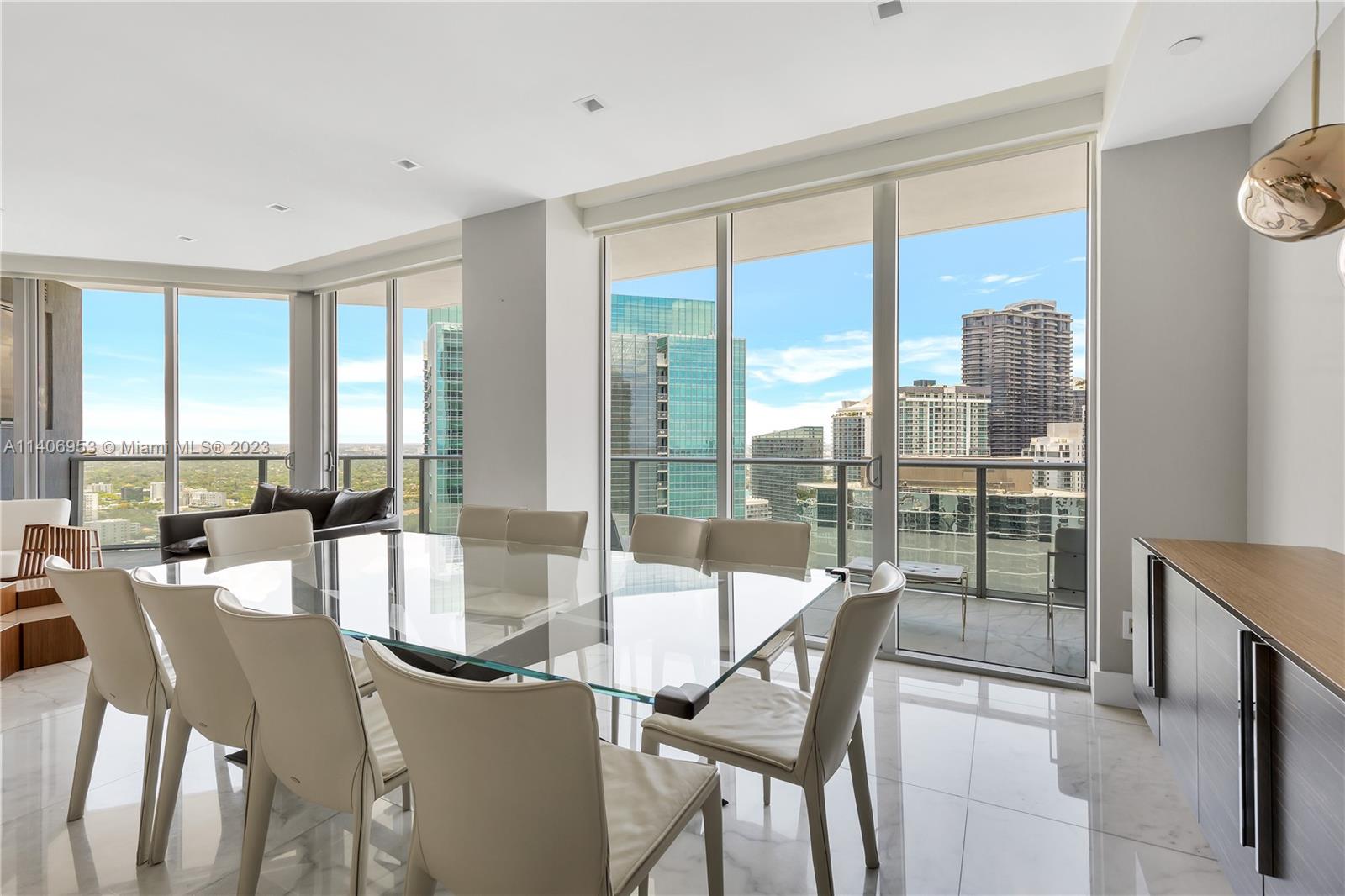 Brickell Miami, FL 33131 - Photo 13 of 41 a dining room with furniture and a floor to ceiling window