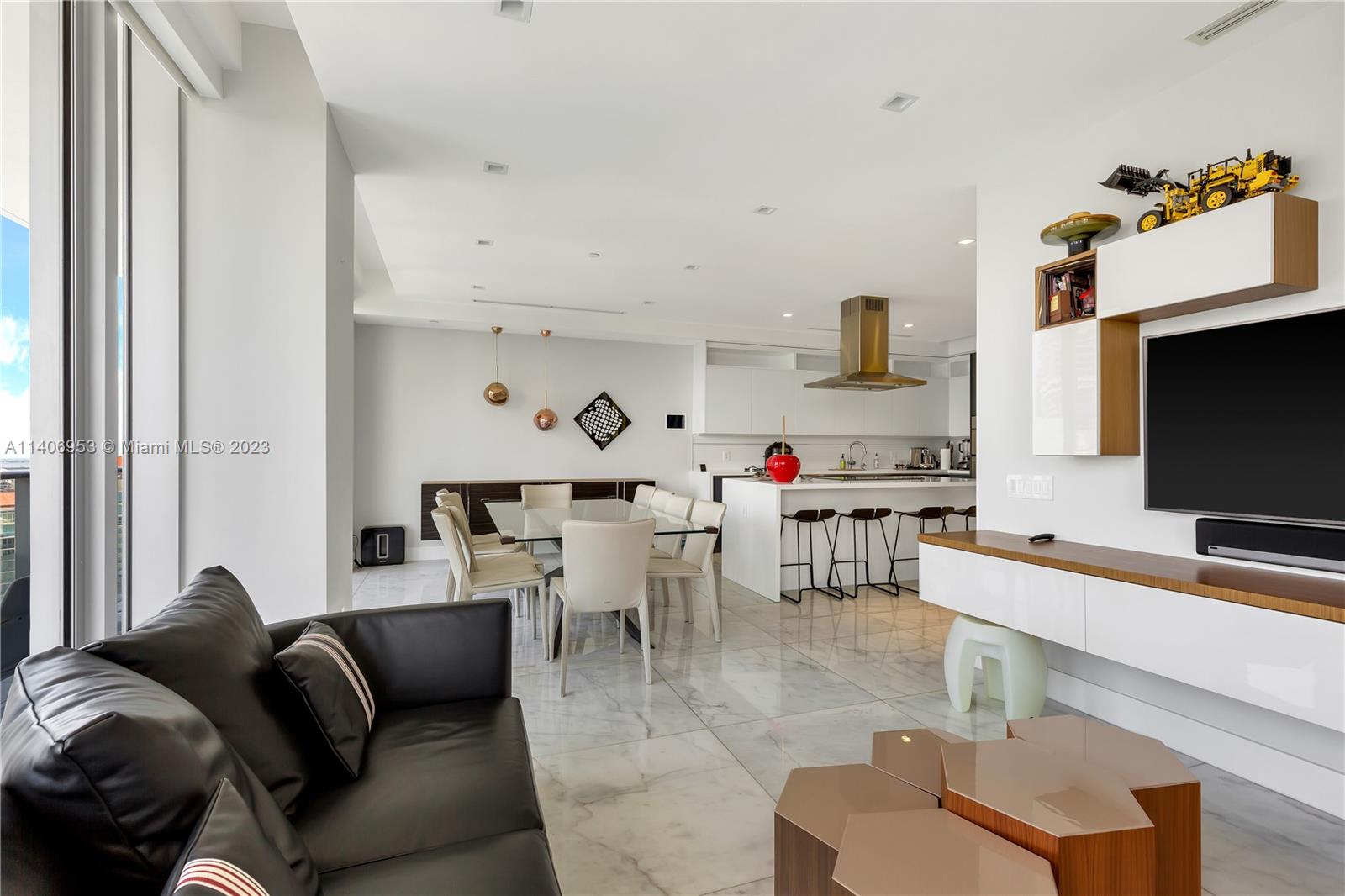 Brickell Miami, FL 33131 - Photo 16 of 41 a living room with furniture and a flat screen tv