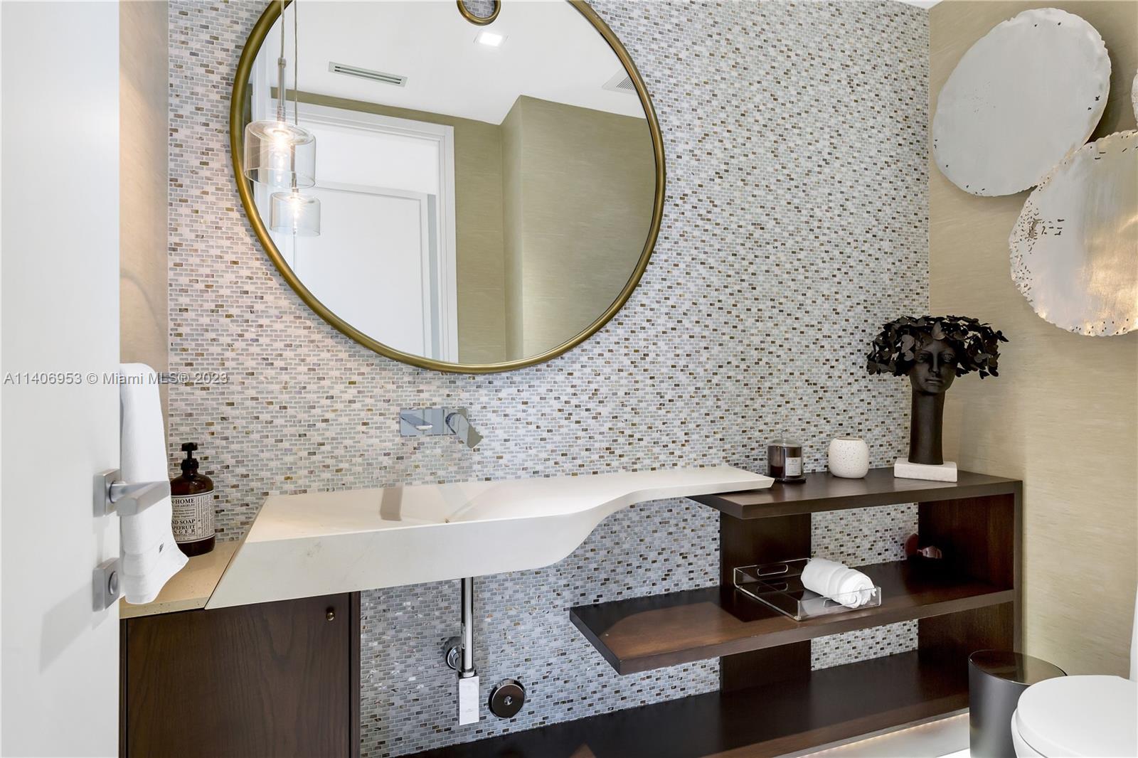 Brickell Miami, FL 33131 - Photo 17 of 41 a bathroom with a sink and a mirror