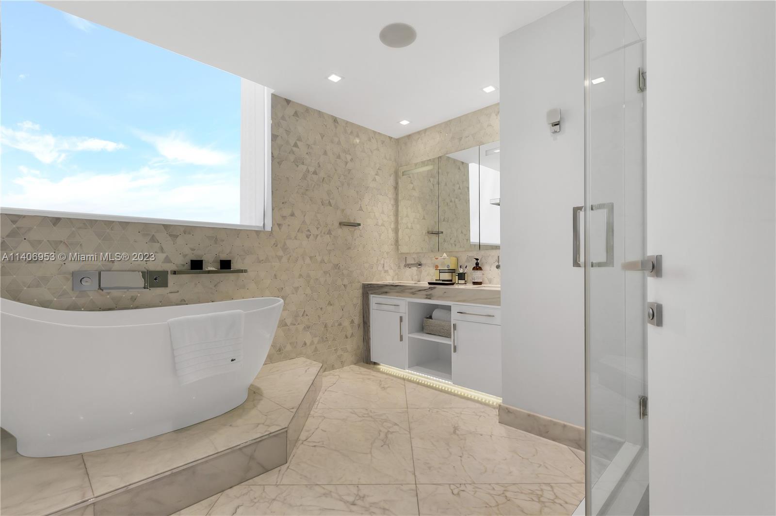 Brickell Miami, FL 33131 - Photo 23 of 41 a bathroom with a tub sink and mirror