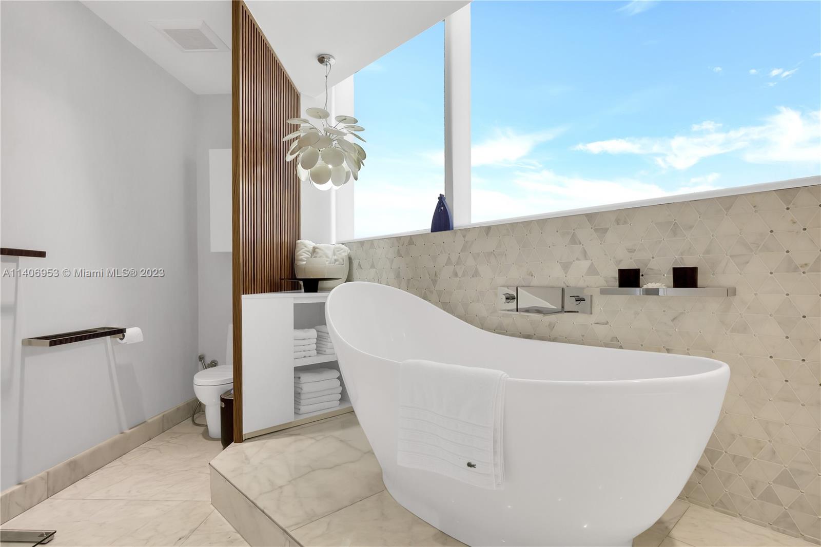 Brickell Miami, FL 33131 - Photo 25 of 41 a white bath tub sitting in a bathroom
