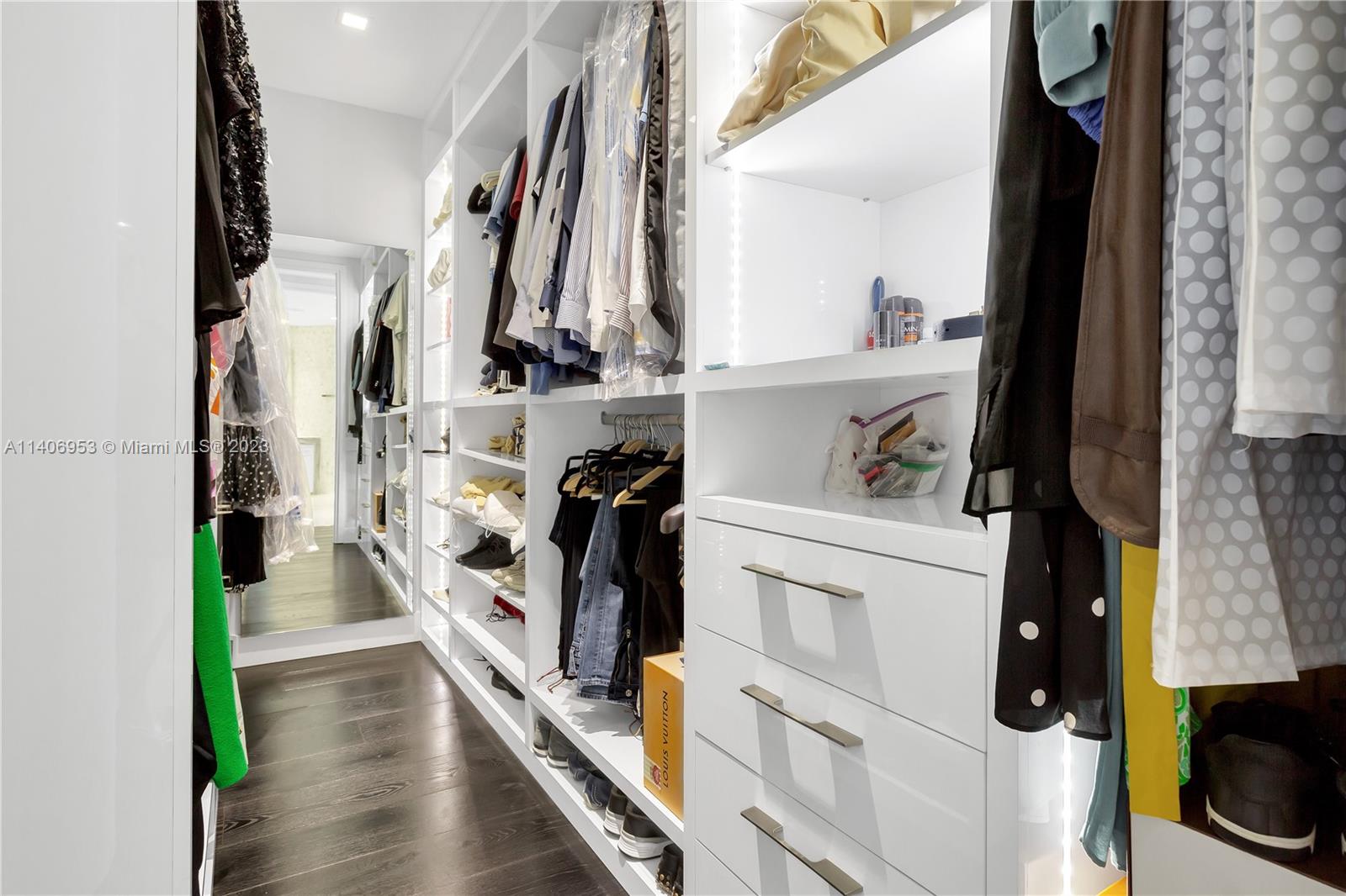 Brickell Miami, FL 33131 - Photo 26 of 41 a view of walk in closet with clothes and shoes