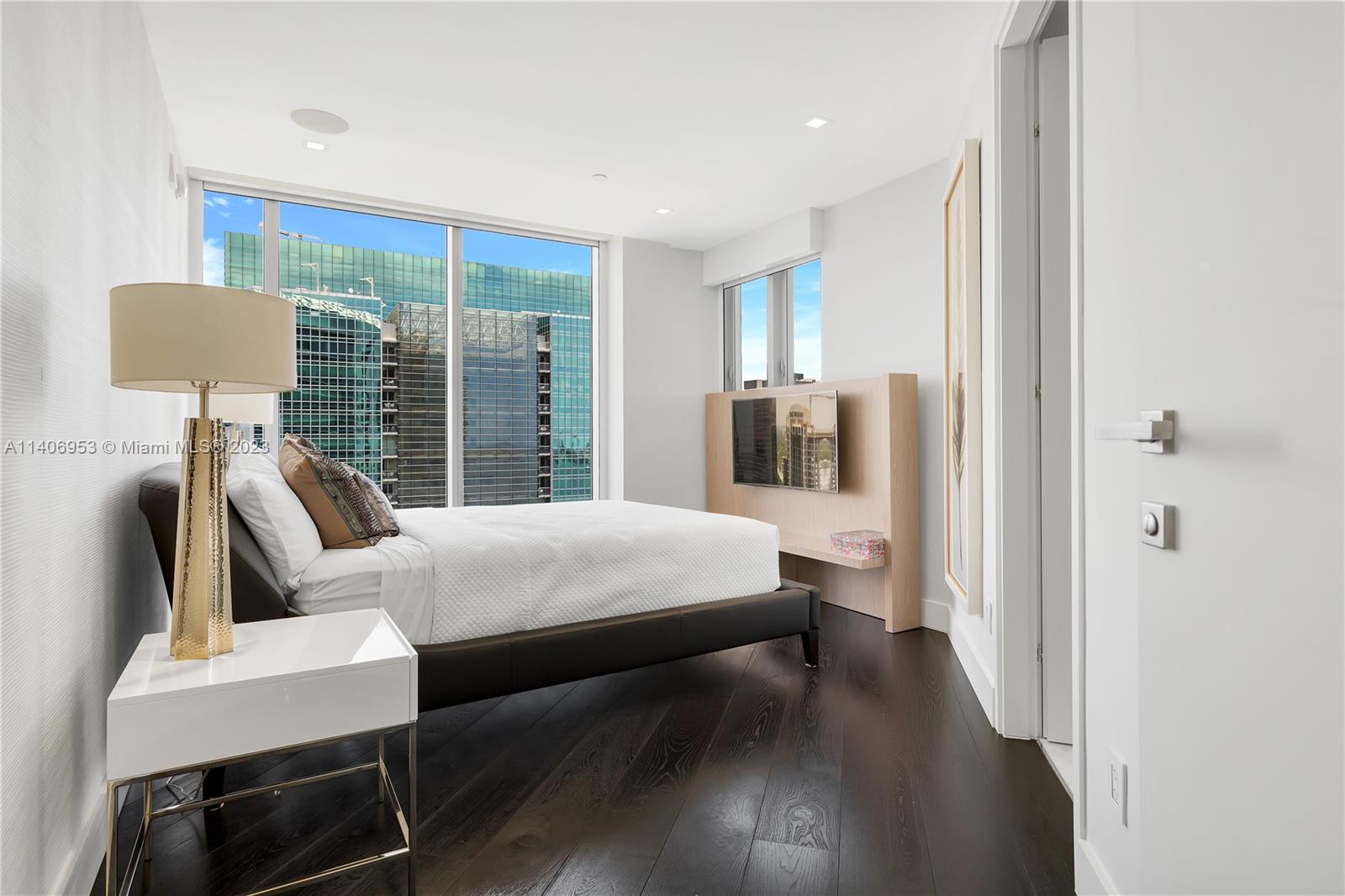 Brickell Miami, FL 33131 - Photo 27 of 41 a bedroom with a bed a table and painting