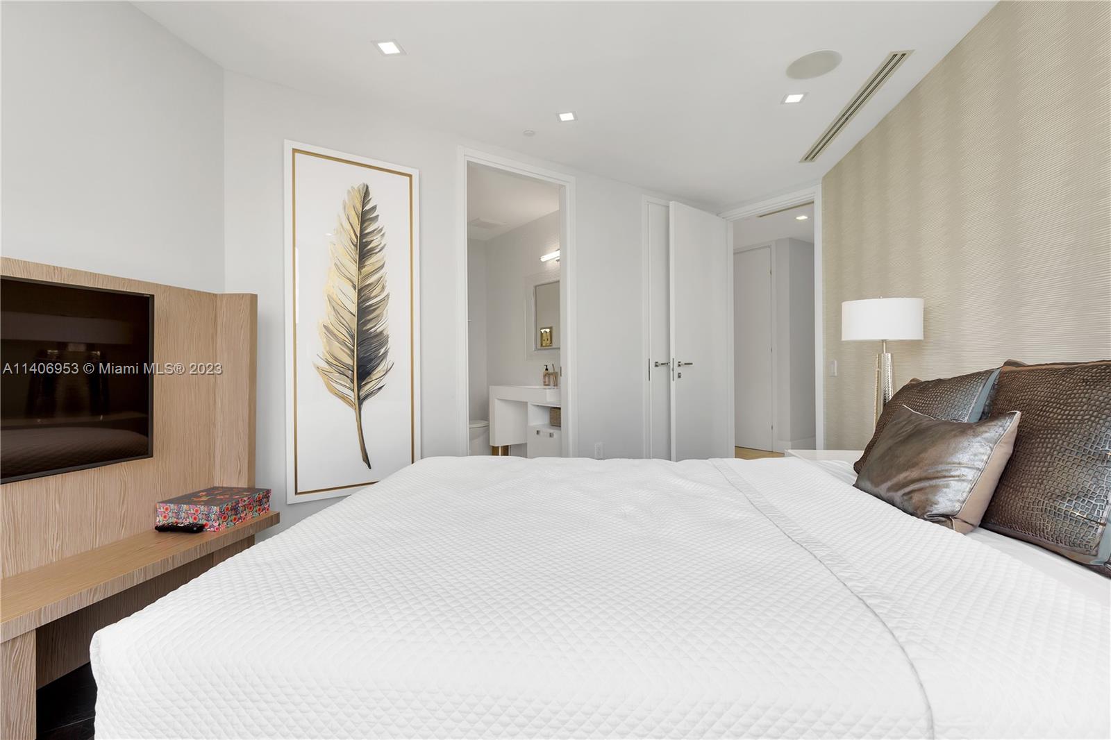 Brickell Miami, FL 33131 - Photo 30 of 41 a bedroom with a bed and a flat screen tv