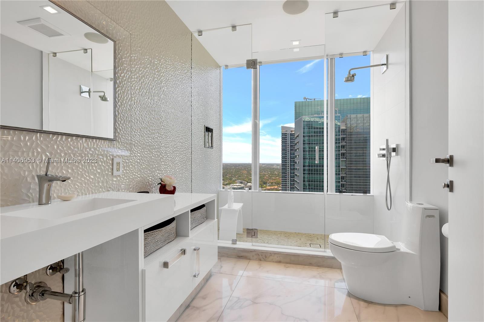 Brickell Miami, FL 33131 - Photo 33 of 41 a bathroom with a sink a toilet and a large mirror