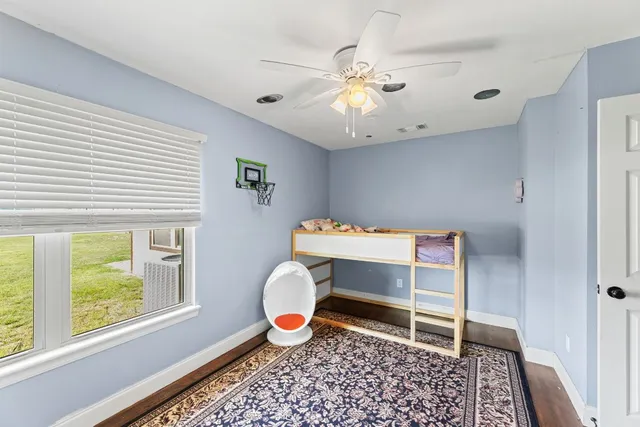 a large kitchen with stainless steel appliances kitchen island granite countertop a stove refrigerator and cabinets