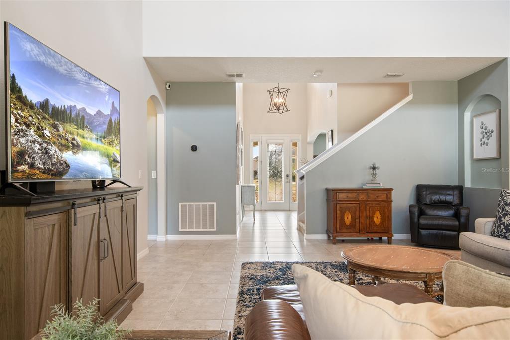 615 Timbervale Trail Clermont, FL 34715 - Photo 20 of 100 a living room with furniture and a flat screen tv
