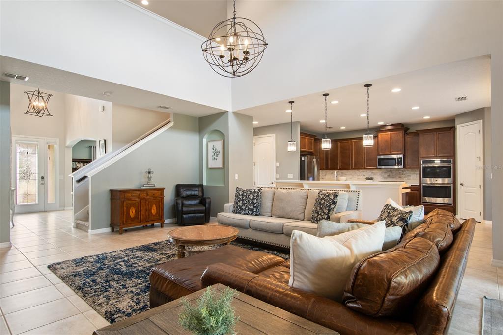 615 Timbervale Trail Clermont, FL 34715 - Photo 21 of 100 a living room with furniture kitchen view and a fireplace