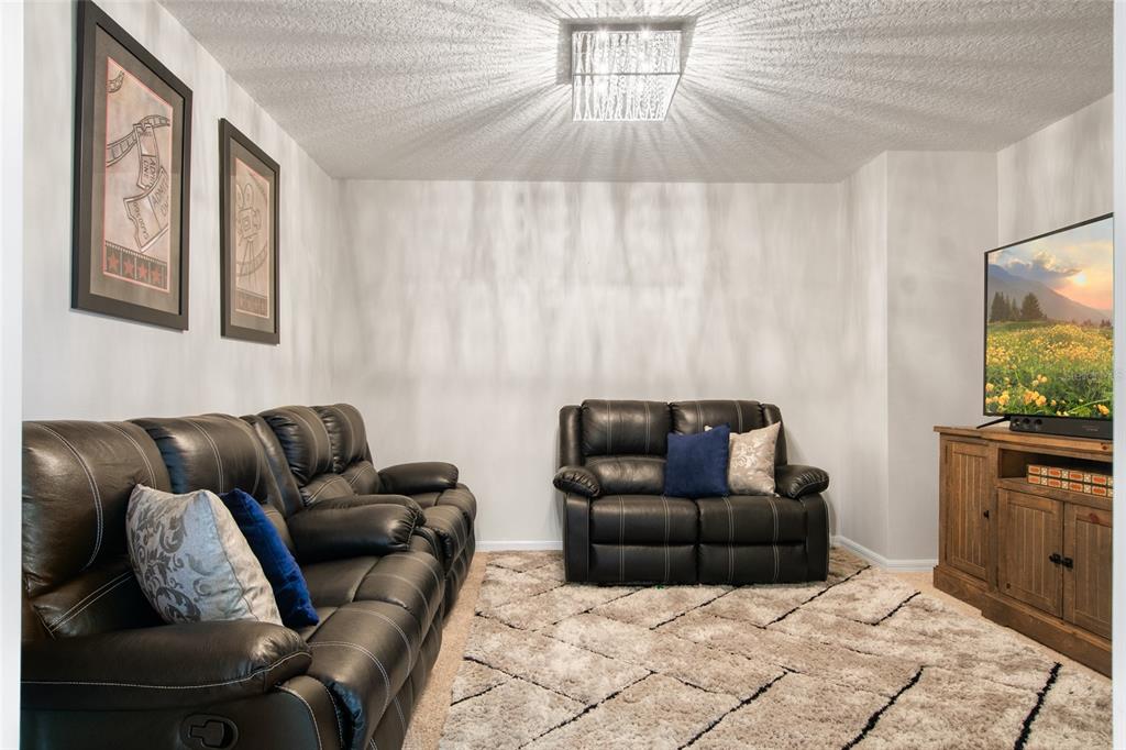 615 Timbervale Trail Clermont, FL 34715 - Photo 45 of 100 a living room with furniture and a flat screen tv