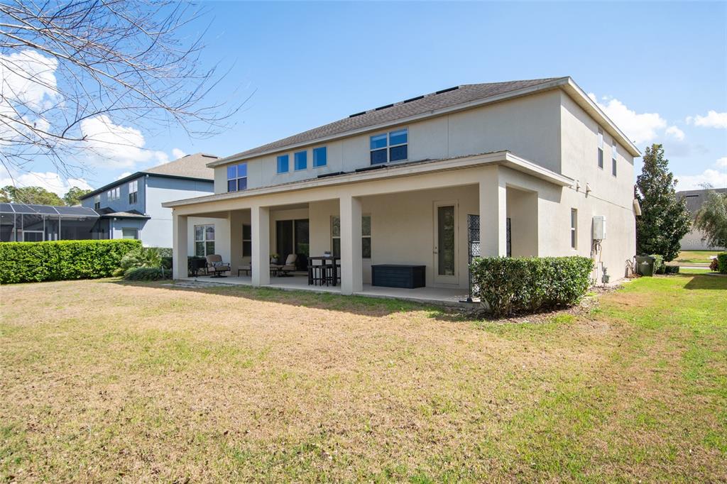 615 Timbervale Trail Clermont, FL 34715 - Photo 52 of 100 a view of a white house with a large yard and large tree