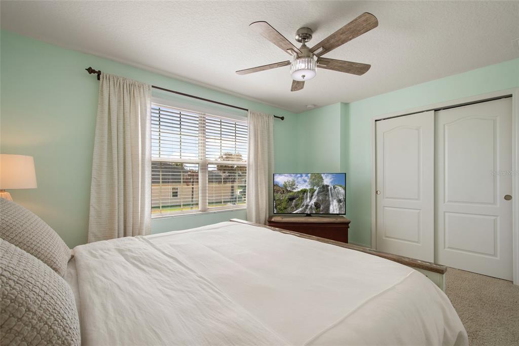 615 Timbervale Trail Clermont, FL 34715 - Photo 56 of 100 a bedroom with a large bed and a large window
