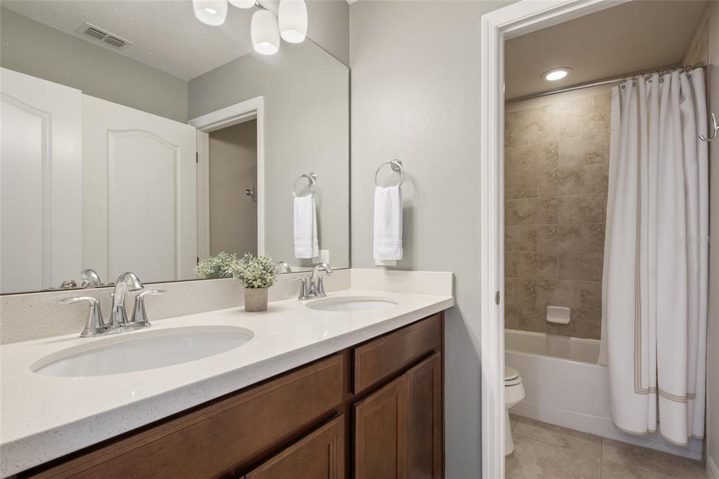 615 Timbervale Trail Clermont, FL 34715 - Photo 57 of 100 a bathroom with double sink and a mirror