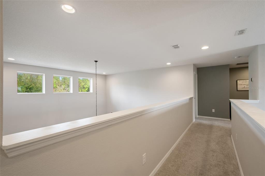 615 Timbervale Trail Clermont, FL 34715 - Photo 61 of 100 a view of an empty room with wooden floor and a window