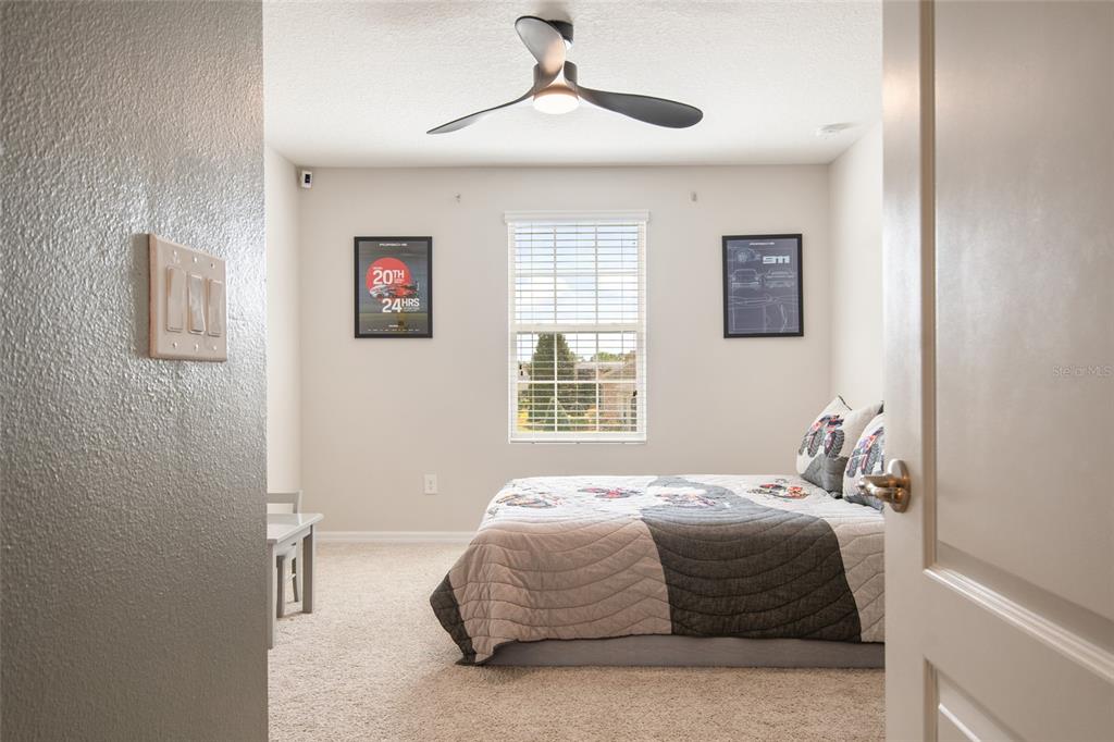 615 Timbervale Trail Clermont, FL 34715 - Photo 63 of 100 a bedroom with a bed and a window