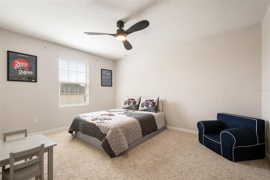 615 Timbervale Trail Clermont, FL 34715 - Photo 64 of 100 a bedroom with a bed and a couch