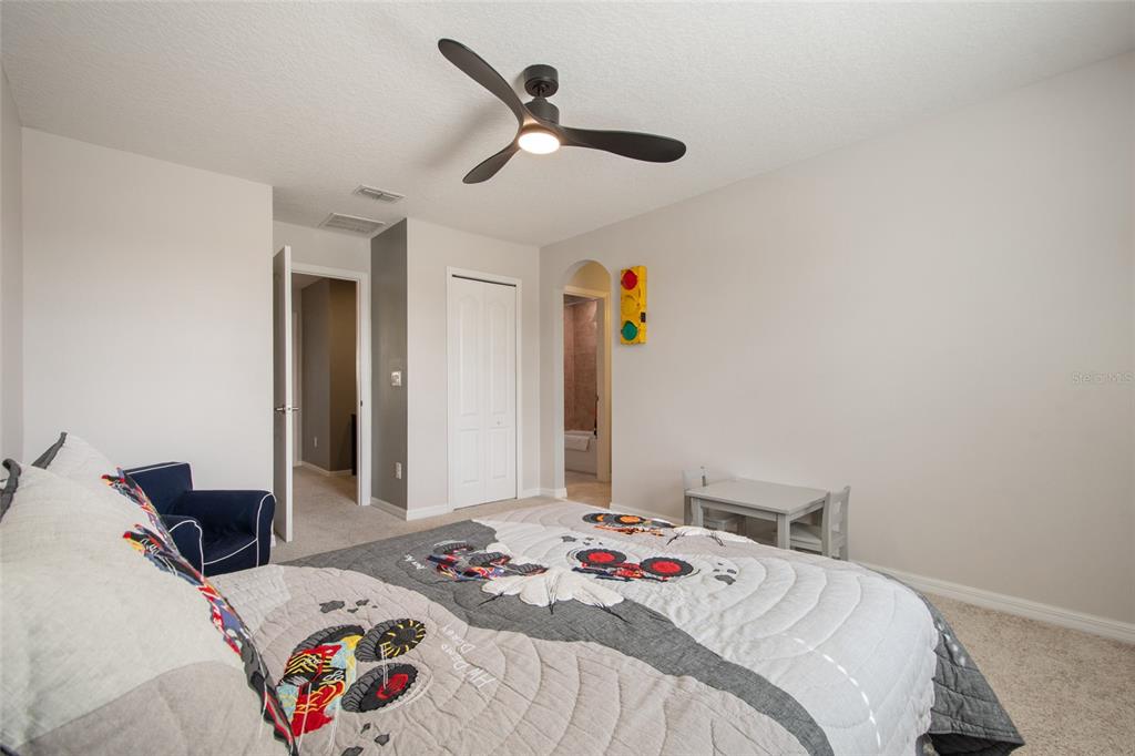 615 Timbervale Trail Clermont, FL 34715 - Photo 65 of 100 a bedroom that has a bed and a chandelier