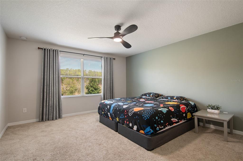 615 Timbervale Trail Clermont, FL 34715 - Photo 69 of 100 a bed sitting in a bedroom next to a window