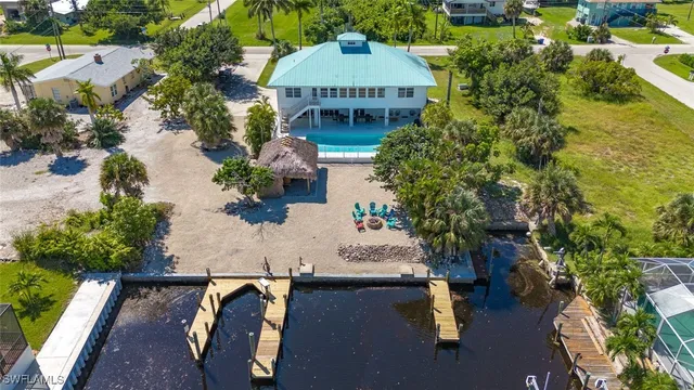 an aerial view of a house with yard swimming pool and outdoor seating