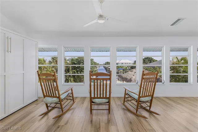a view of a room with furniture wooden floor and windows