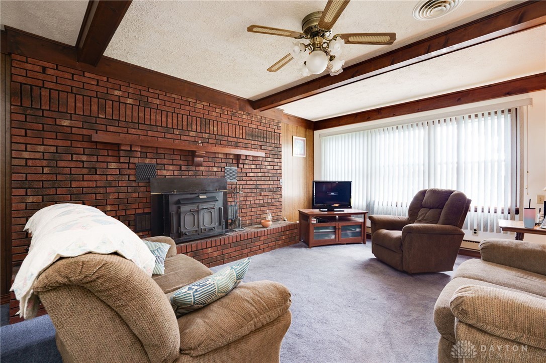 830 South Fuls Road New Lebanon, OH 45345 - Photo 11 of 28 WOW! Super nice family room with brick accent wall and super duper comfy buck stove insert to keep you warm at night.