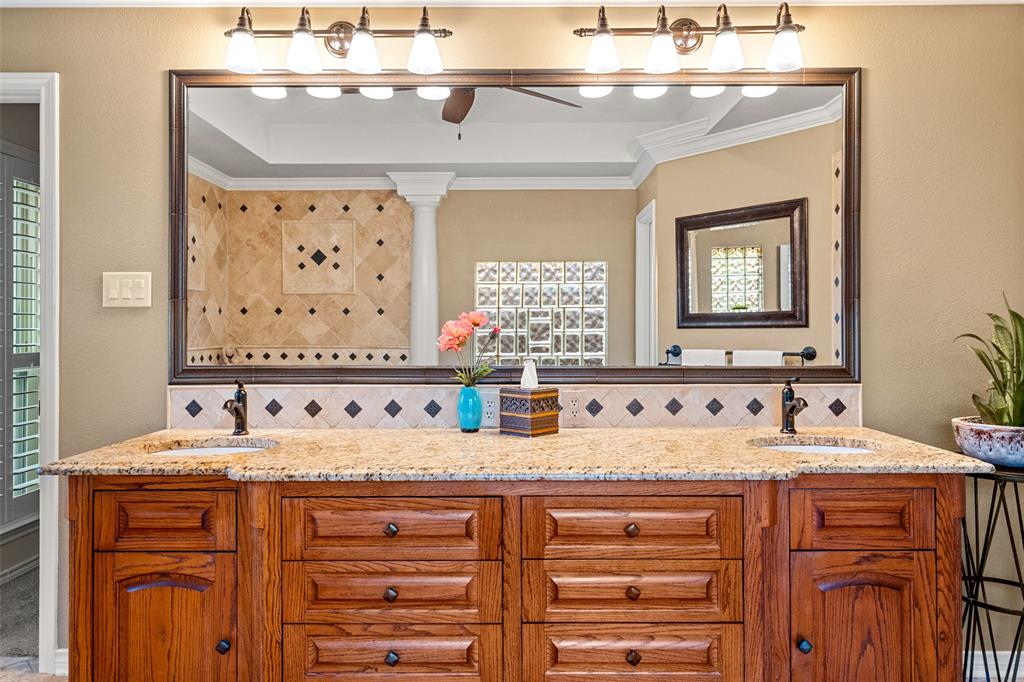 400 Hunters Ridge Circle Coppell, TX 75019 - Photo 17 of 35 a bathroom with a sink vanity and a mirror