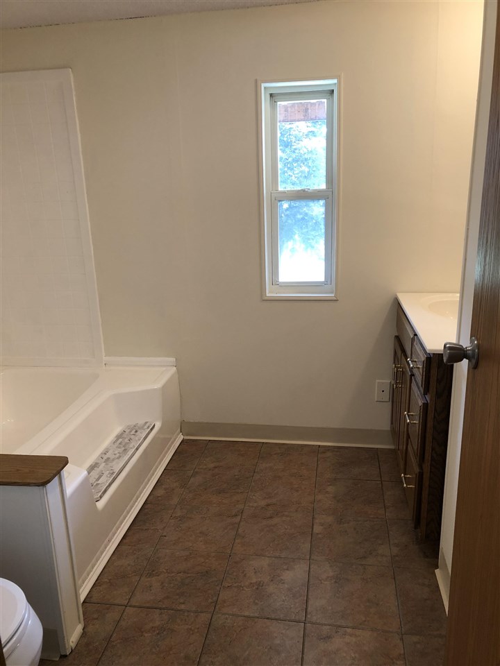 1676 Whitney Road Franklin Grove, IL 61031 - Photo 12 of 28 a bathroom with a bathtub