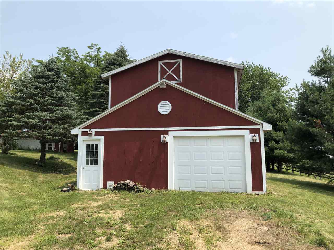 1676 Whitney Road Franklin Grove, IL 61031 - Photo 2 of 28 a front view of a house with a yard