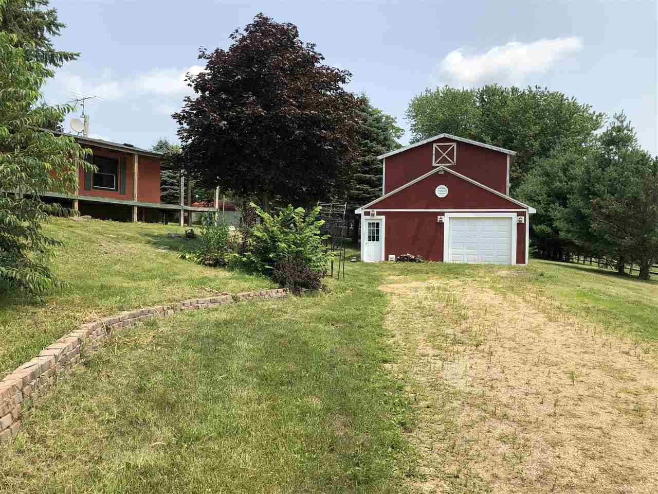 1676 Whitney Road Franklin Grove, IL 61031 - Photo 25 of 28 a front view of a house with a yard