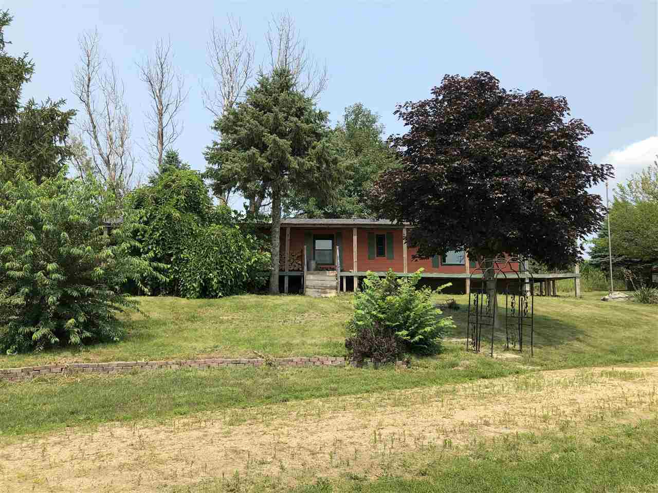 1676 Whitney Road Franklin Grove, IL 61031 - Photo 3 of 28 a view of a house with a yard and a large tree