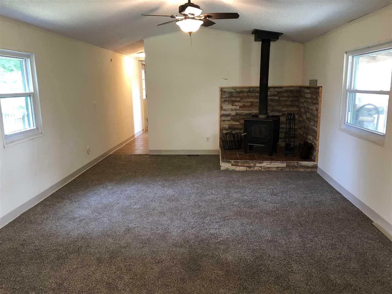 1676 Whitney Road Franklin Grove, IL 61031 - Photo 5 of 28 a view of an empty room with a fireplace