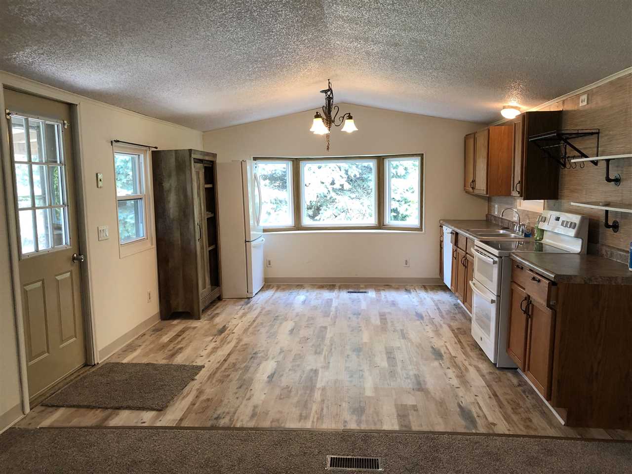 1676 Whitney Road Franklin Grove, IL 61031 - Photo 6 of 28 an empty room with wooden floor and windows
