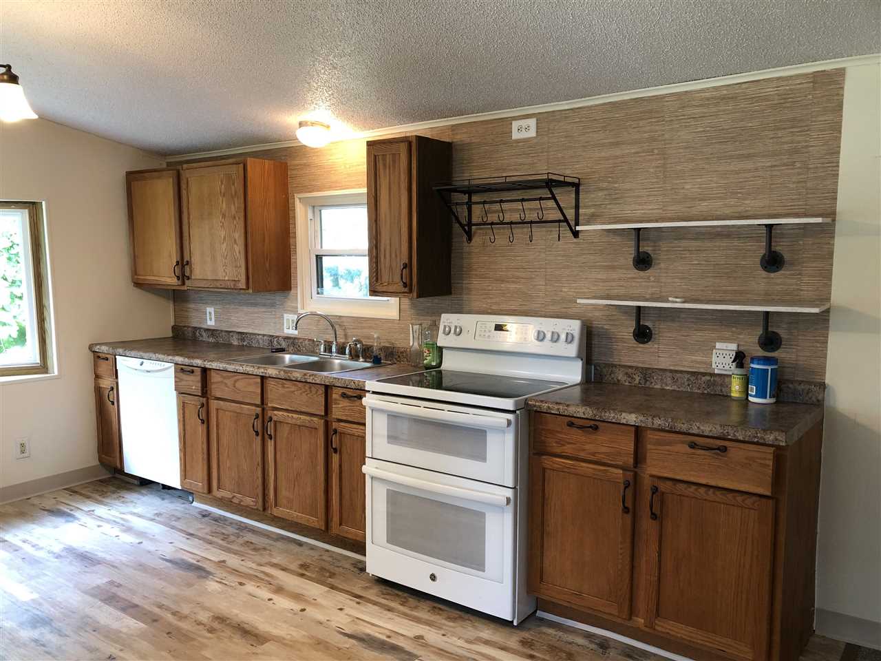 1676 Whitney Road Franklin Grove, IL 61031 - Photo 7 of 28 a kitchen with stainless steel appliances granite countertop a sink and cabinets