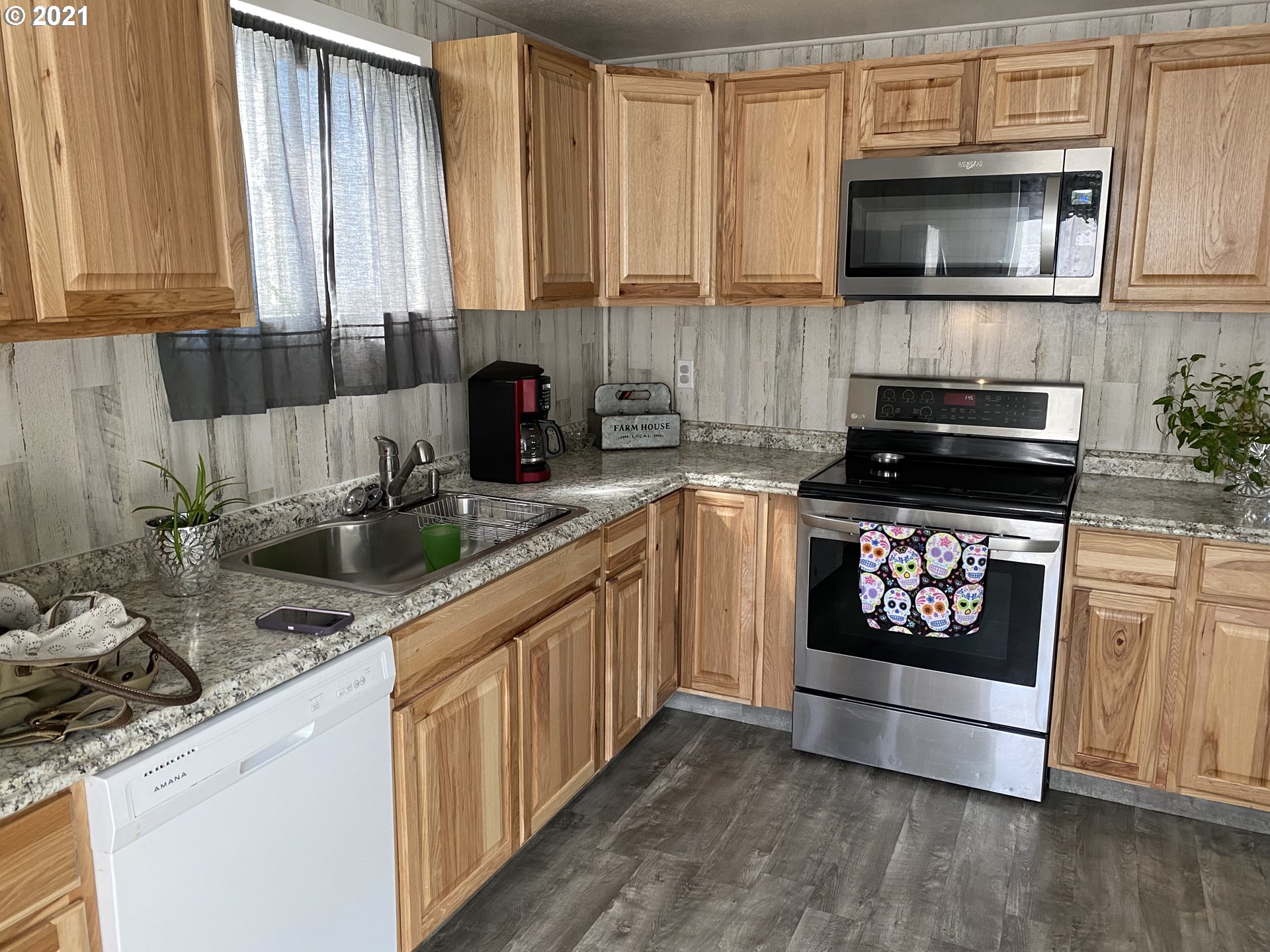1515 Southwest Frazer Avenue Pendleton, OR 97801 - Photo 4 of 11 a kitchen with stainless steel appliances granite countertop a stove a sink and a microwave