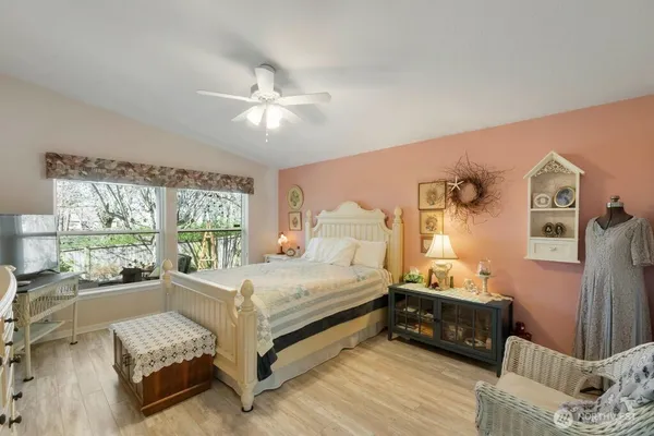 a bedroom with a bed and a large window