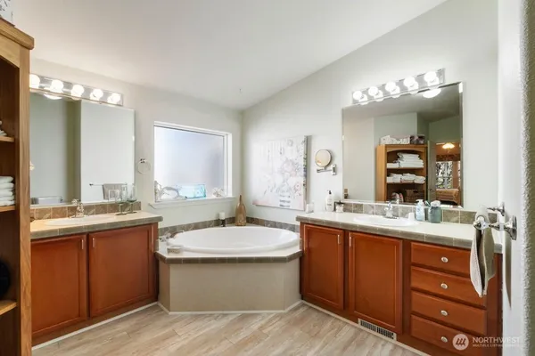 a bathroom with a double vanity sink and a mirror