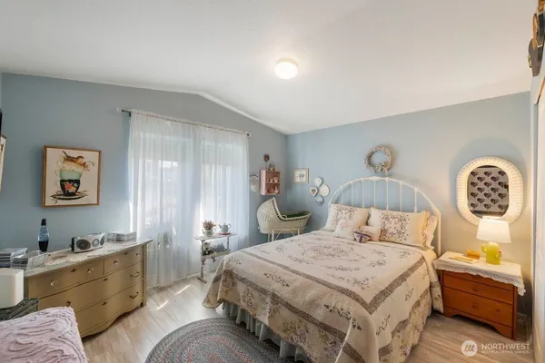 a bedroom with a bed and a table in it