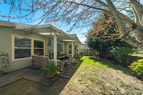 a view of a house with backyard sitting area and garden